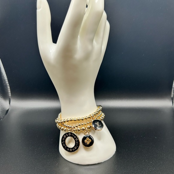 3 LV zipper pull charms on a 3 set gold color stretchable brac… - Picture 1 of 5